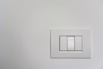 white light switch on white painted wall