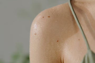 woman in green spaghetti strap top with sweat on body